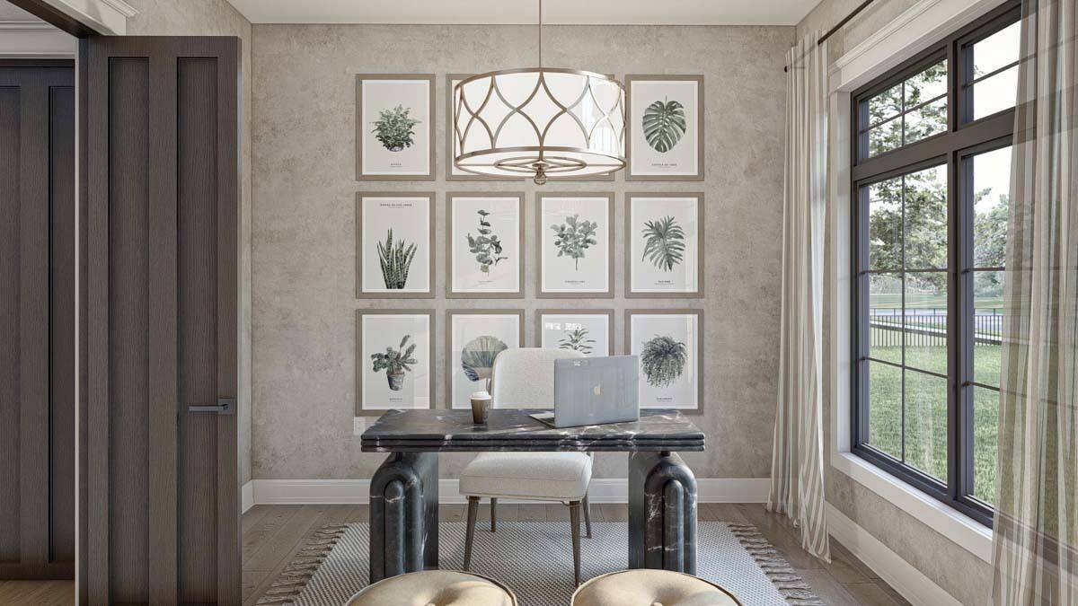 Home office with a gallery wall and a marble desk illuminated by a drum pendant light.
