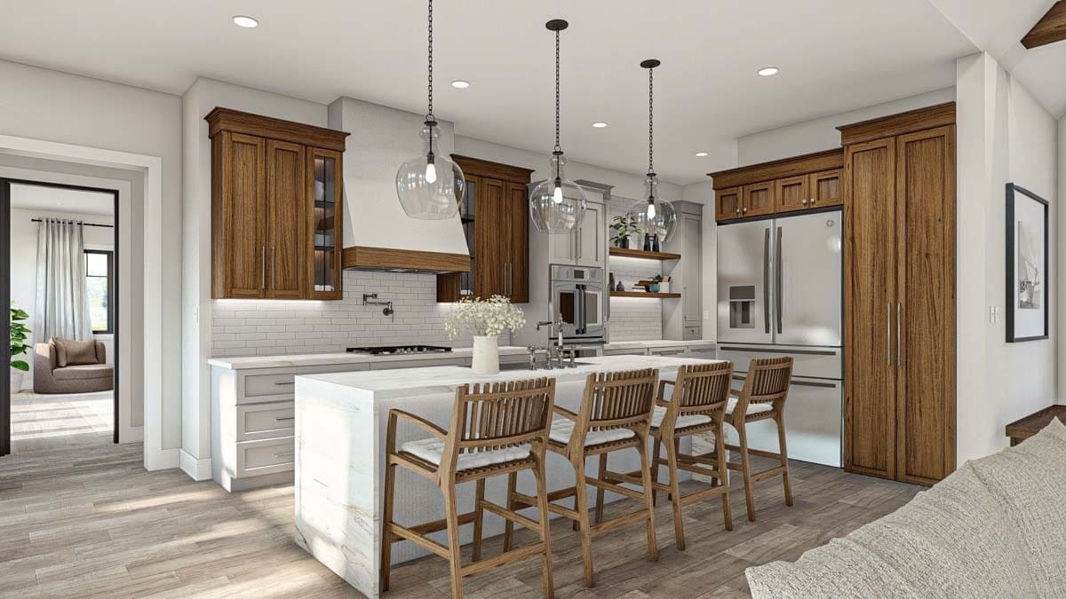 Recessed ceiling lights and glass globe pendants suspended over the island illuminate the kitchen.