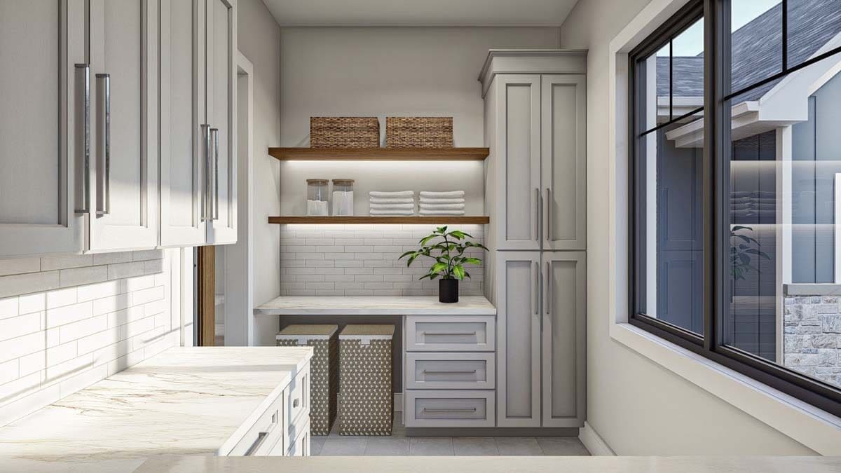 Laundry room with ample storage and marble counters.