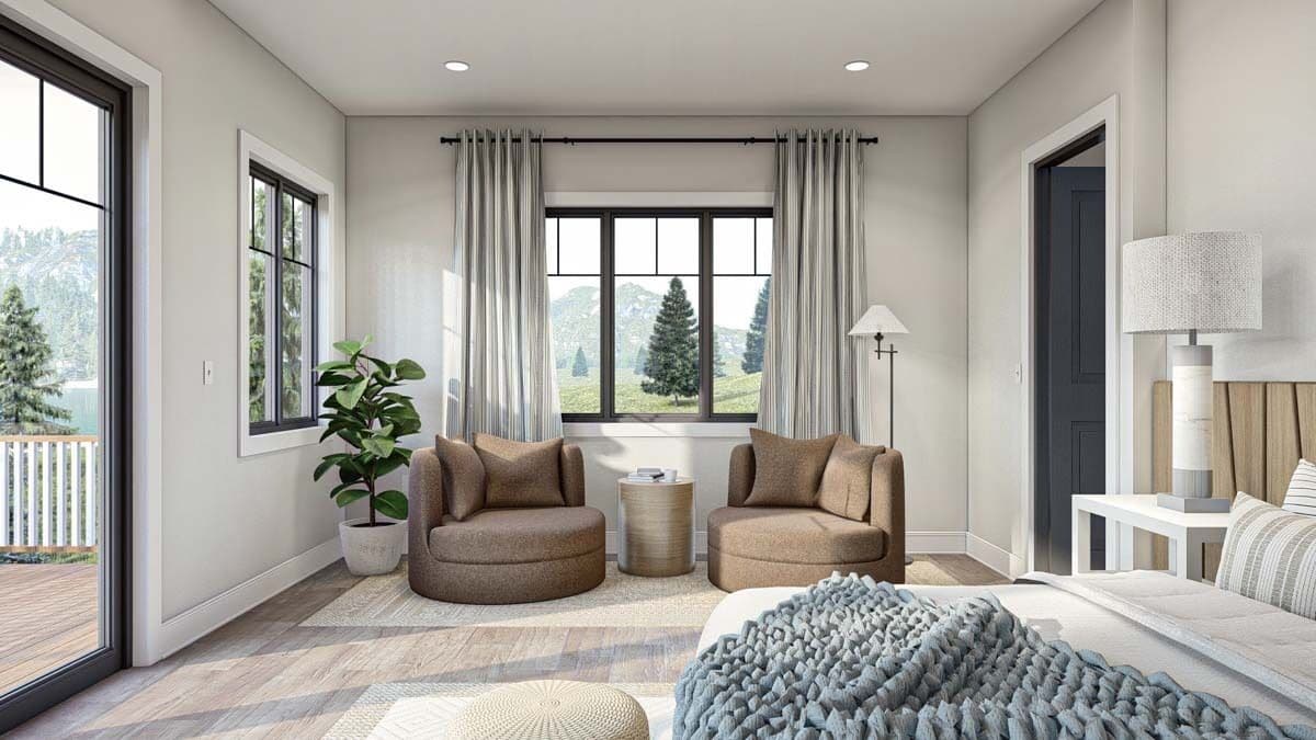 Sitting area with round chairs and a round side table under the framed windows.