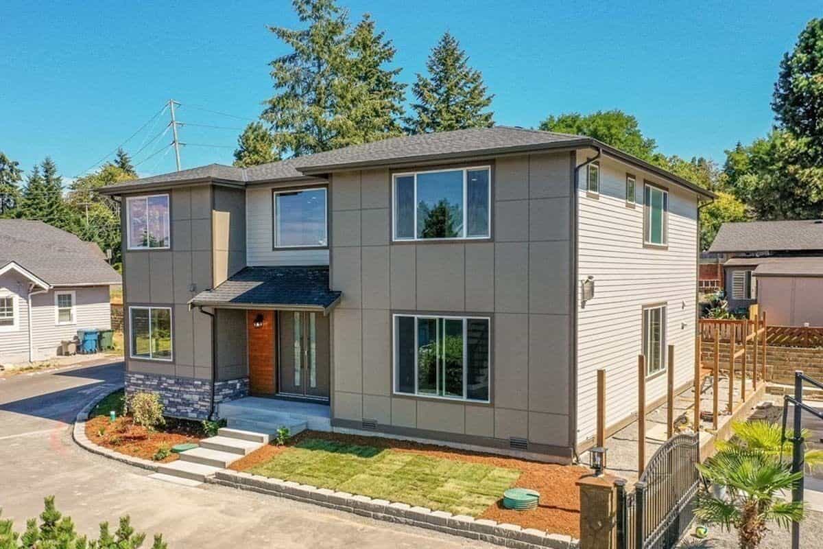 Front-right view with a covered entry and sliding windows.