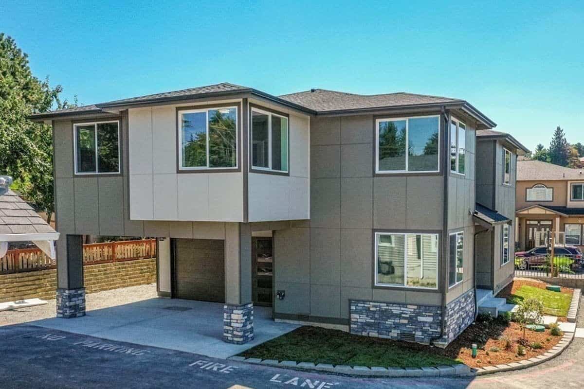 Left view with a covered porch and a double garage.