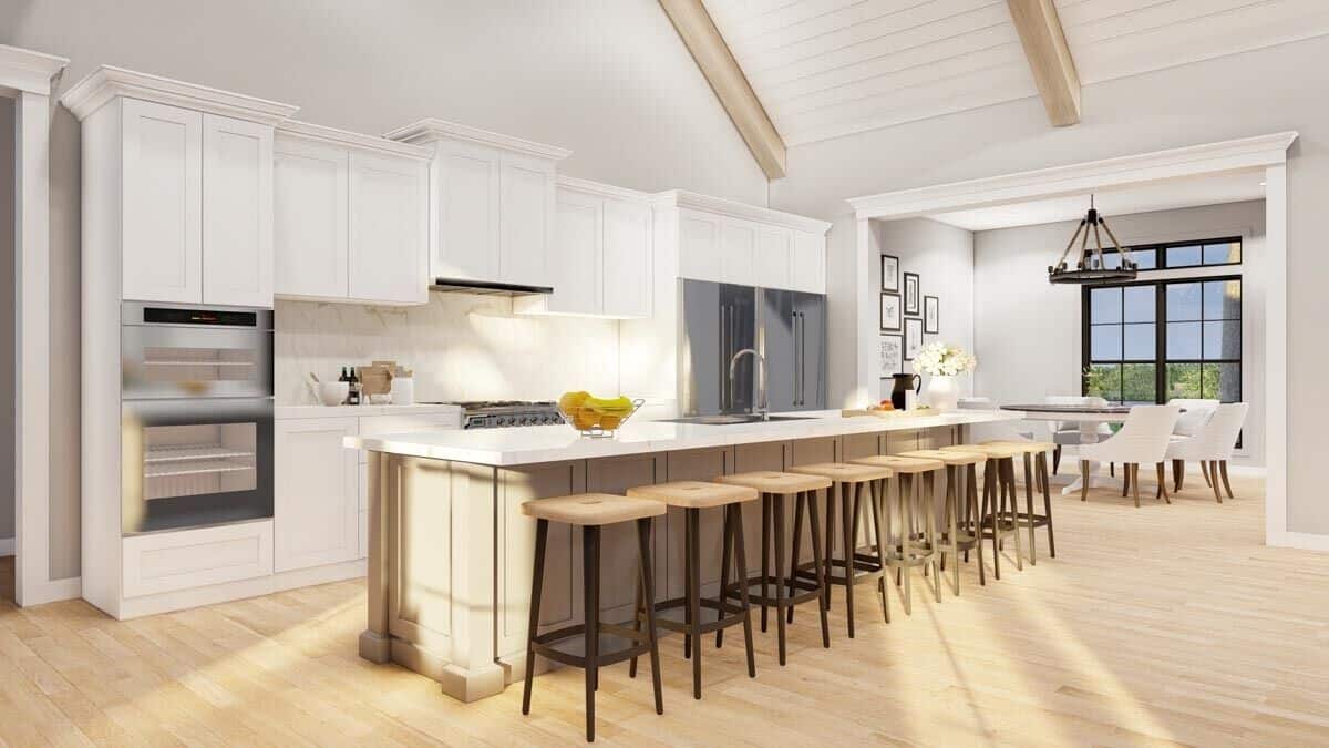 A large opening connects the kitchen and dining room.