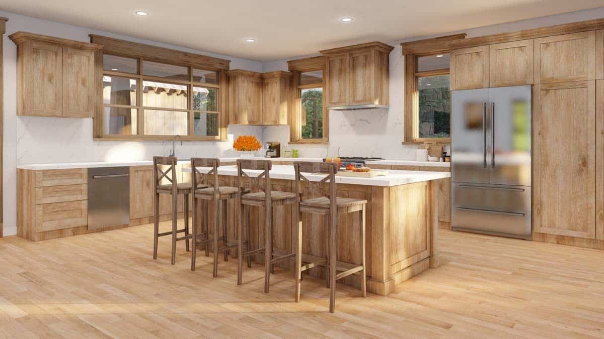 Kitchen with stainless steel appliances, wooden cabinets, and a breakfast island that blends in with the hardwood floor.
