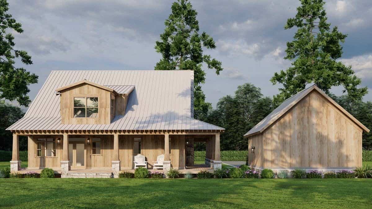 Rear view of the house with a covered porch topped with a large gable dormer.