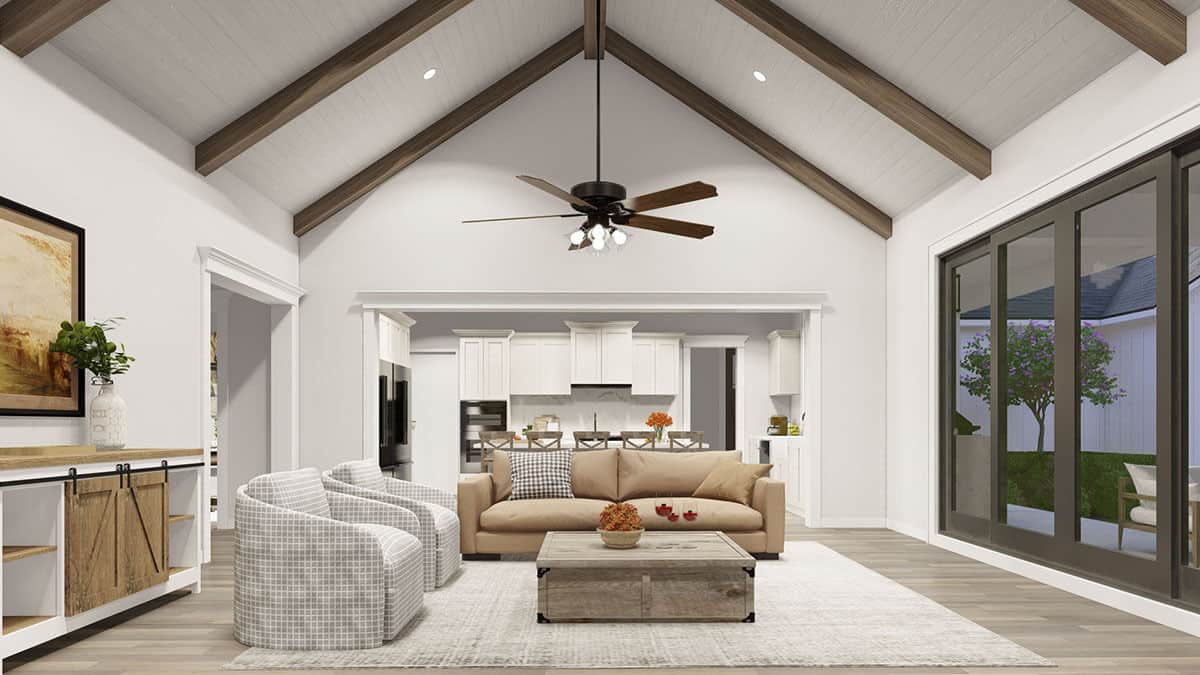 A cathedral ceiling framed with exposed wood beams crowns the great room.