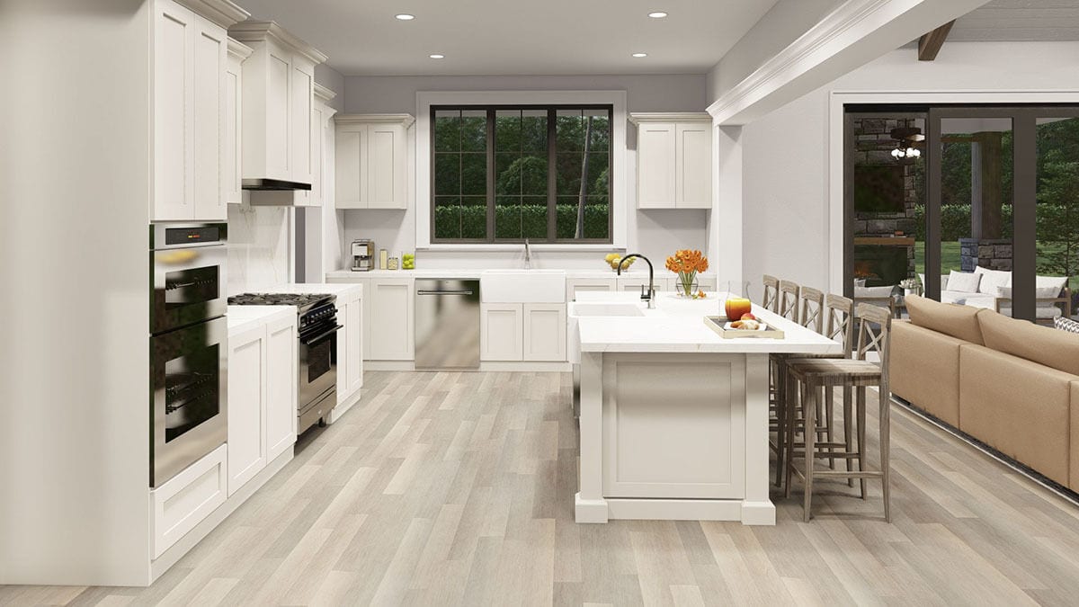 A trio of windows above the farmhouse sink fills the kitchen with natural light.