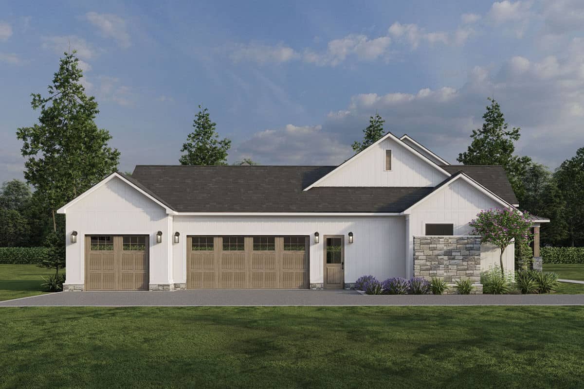 Left view with a 3-car garage and asphalt driveway.