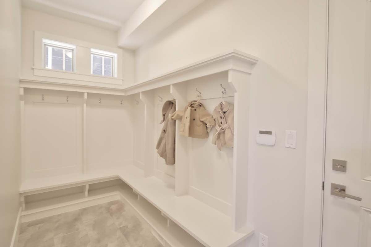 Mudroom with coat hooks and storage bench.