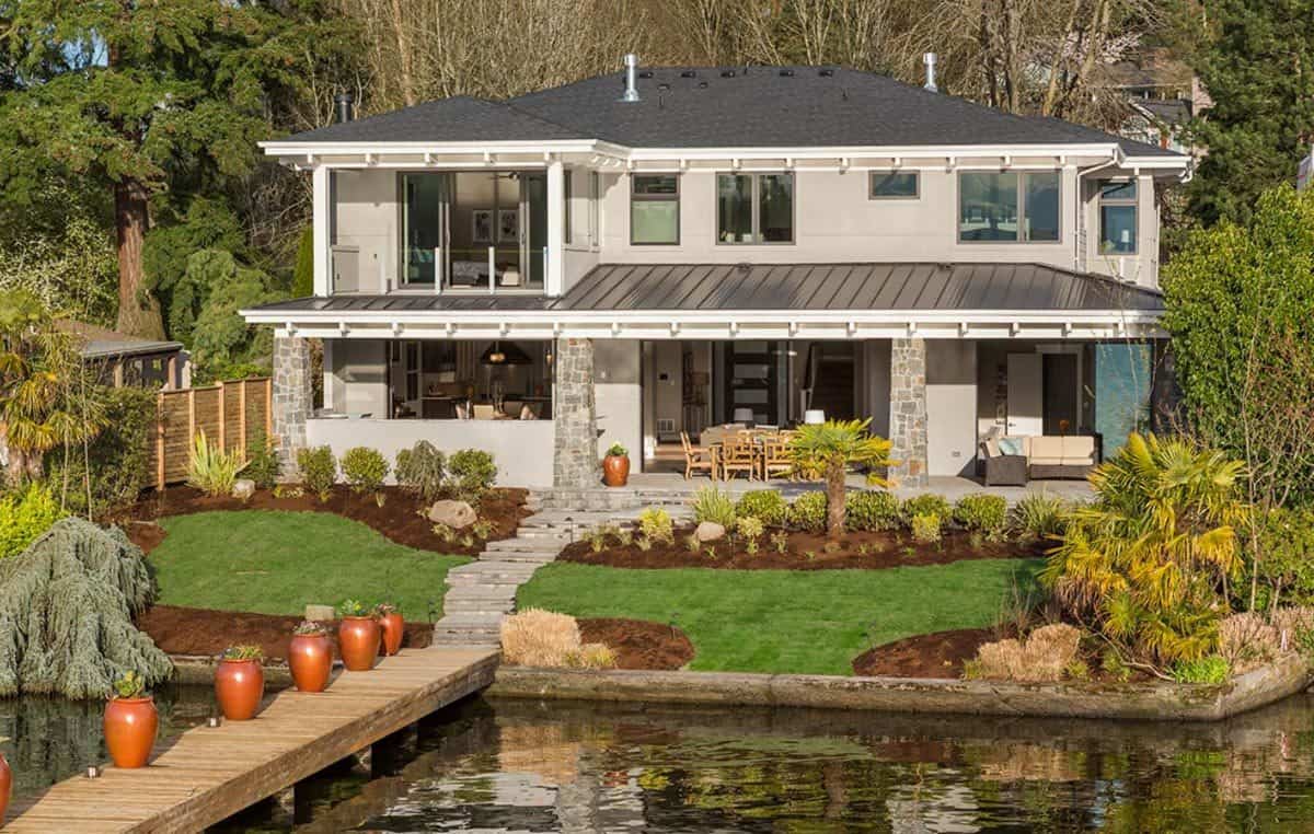Rear view of the house showcasing the covered patios supported by stone columns.