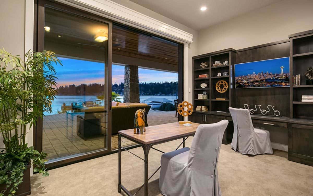 Home office with two desks and sliding glass doors that open to a covered patio.