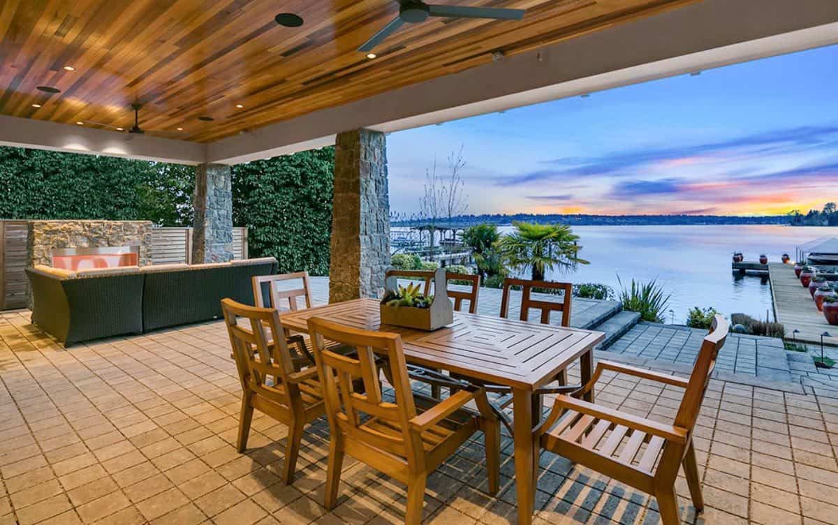 Covered patio with an outdoor dining set under a wood-paneled ceiling.