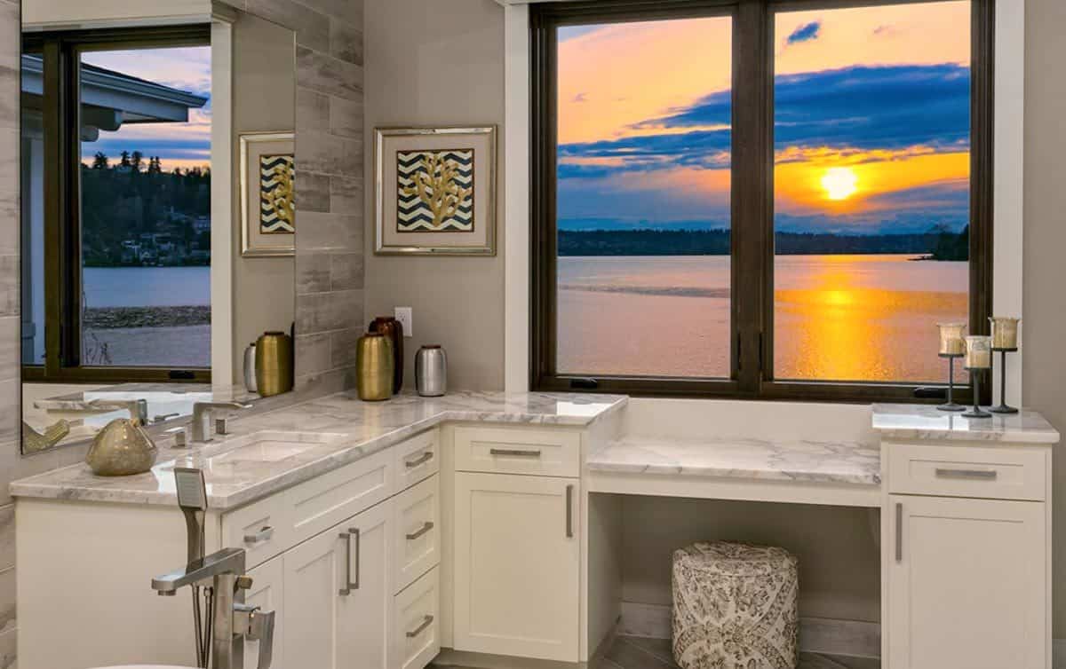 Primary vanity with a makeup counter under the framed windows.