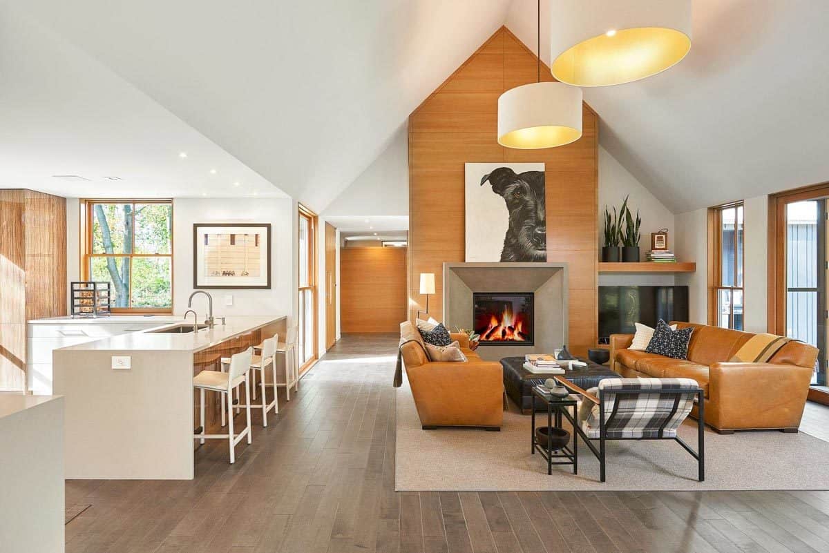Living room and kitchen with hardwood flooring and a cathedral ceiling.