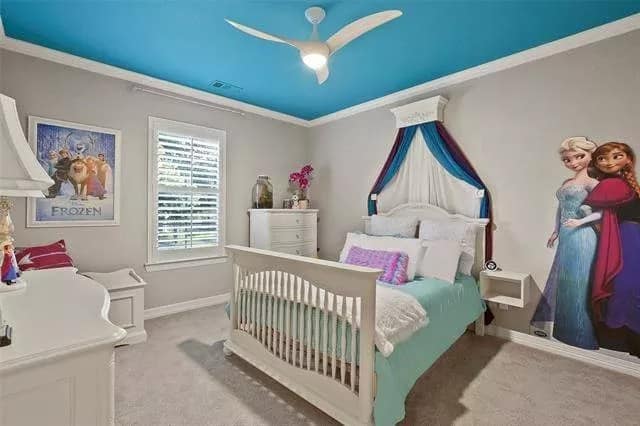 Bedroom with a carpeted floor and white furnishings under a blue regular ceiling.
