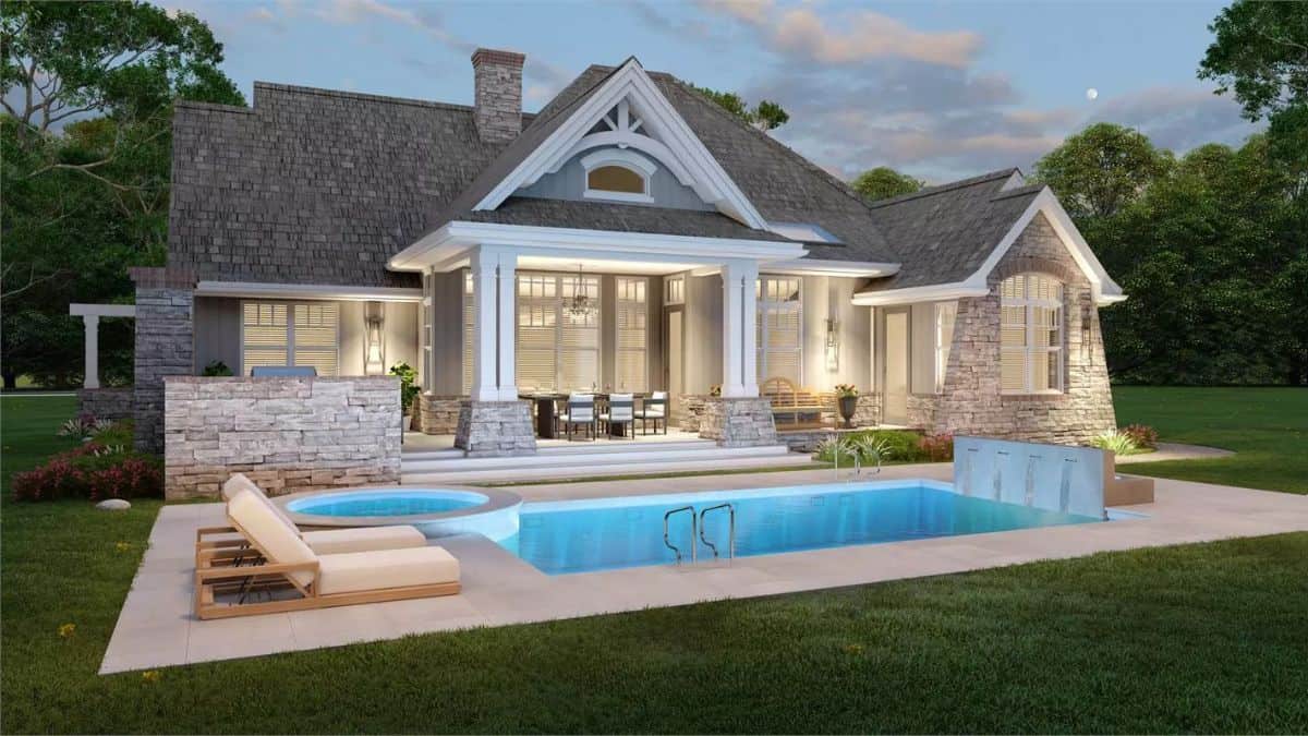 Rear view of the house showcasing the covered porch and swimming pool integrated with a hot tub.
