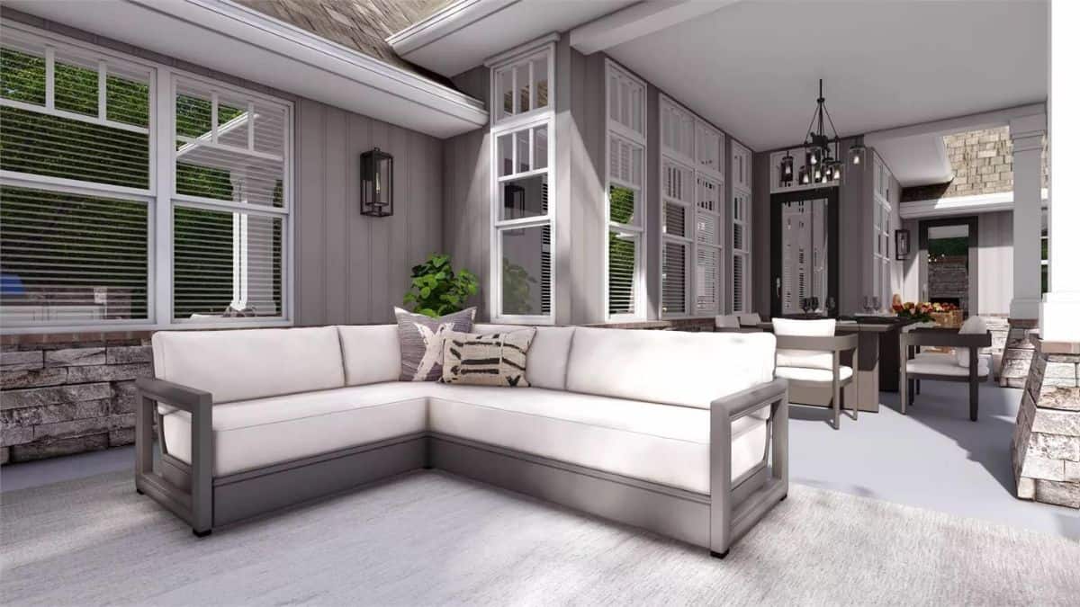 Covered porch with an L-shaped sofa and an outdoor dining set.