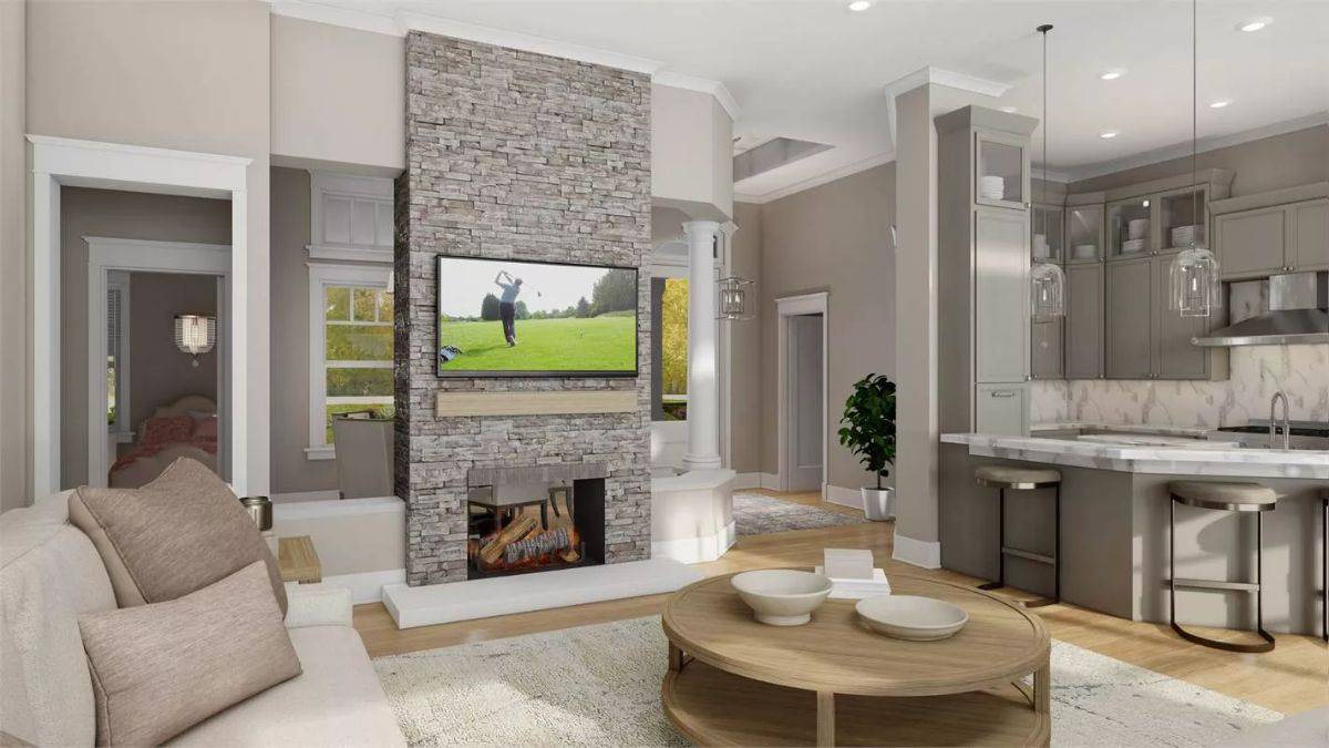 Family room with a round coffee table and a stone fireplace topped with a TV.