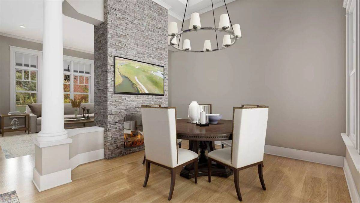 Dining room with a round dining set illuminated by a round chandelier.