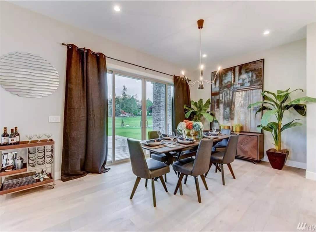 Dining room with a buffet bar, a 6-seater dining set, and sliding glass doors that open onto a covered patio.