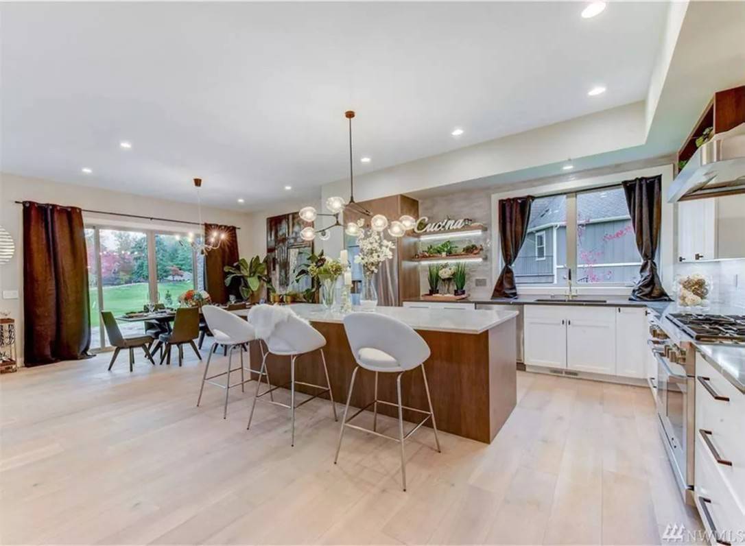 Kitchen with custom cabinetry and a breakfast island with seating for three.