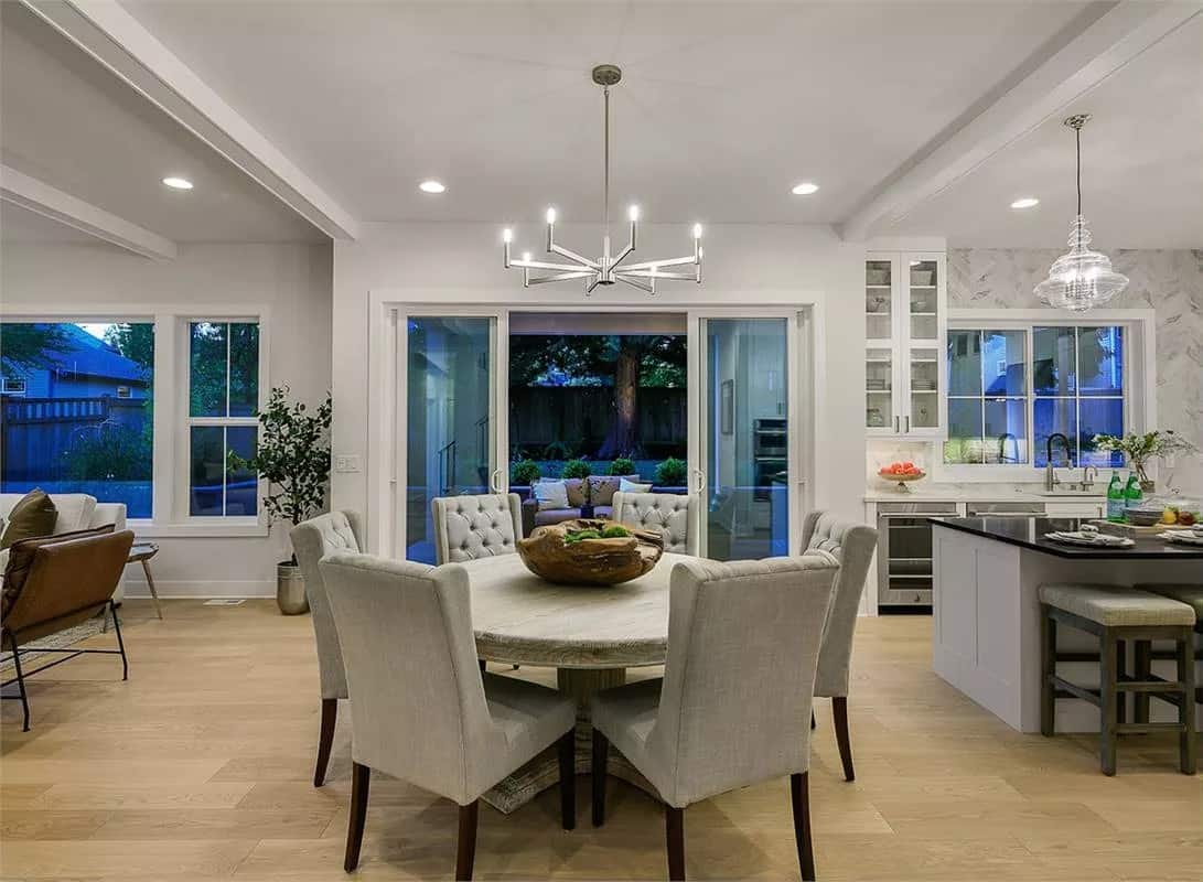 Dining room with a round dining set and sliding glass doors that open onto a covered deck.