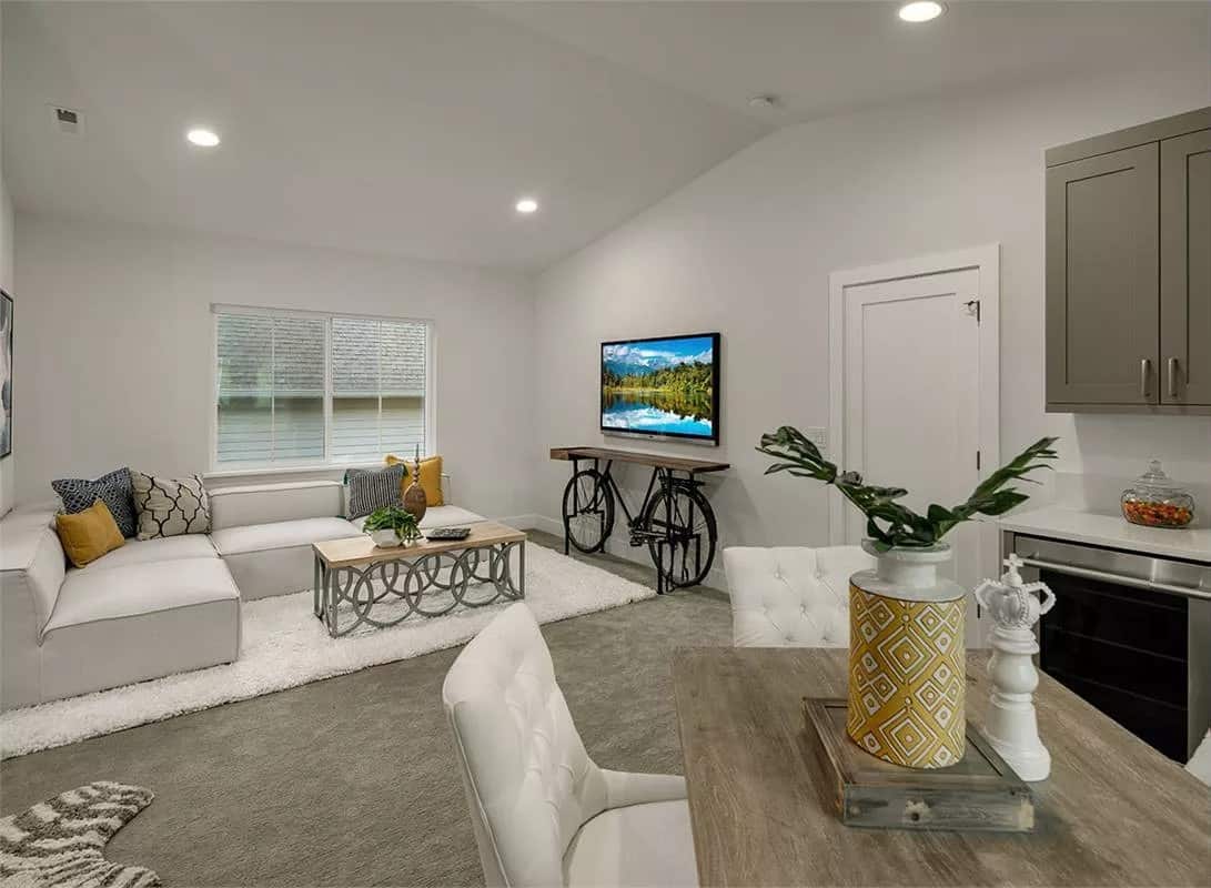 Bonus room with a living space, a dining area, and a bar with a built-in fridge.