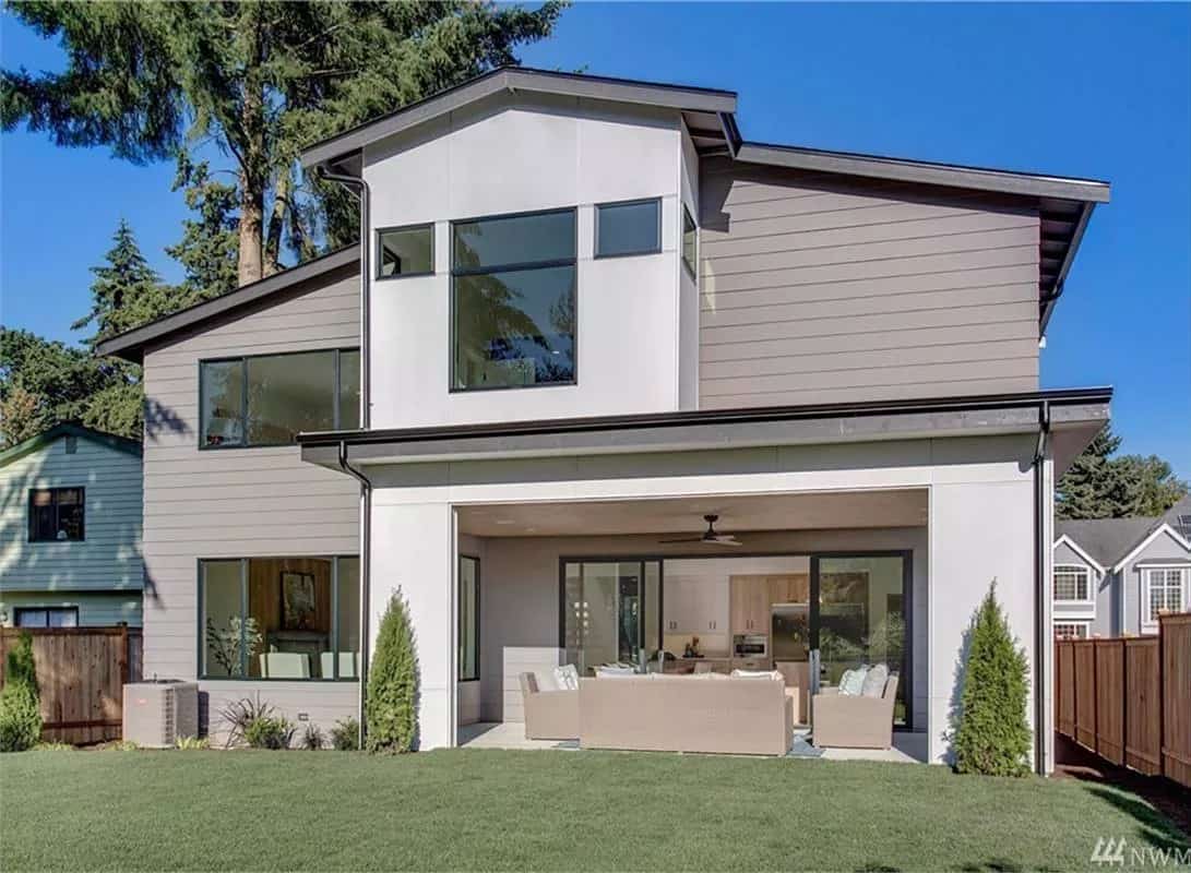 Rear view of the house with sleek windows and a covered outdoor living.