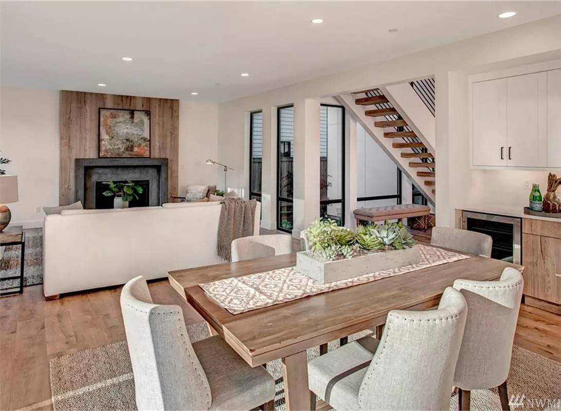 Dining area with a wooden dining table surrounded by upholstered chairs.