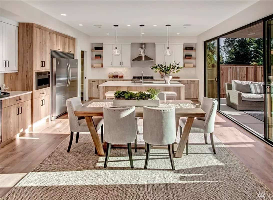 Sliding glass doors extend the eat-in kitchen onto the outdoor living.