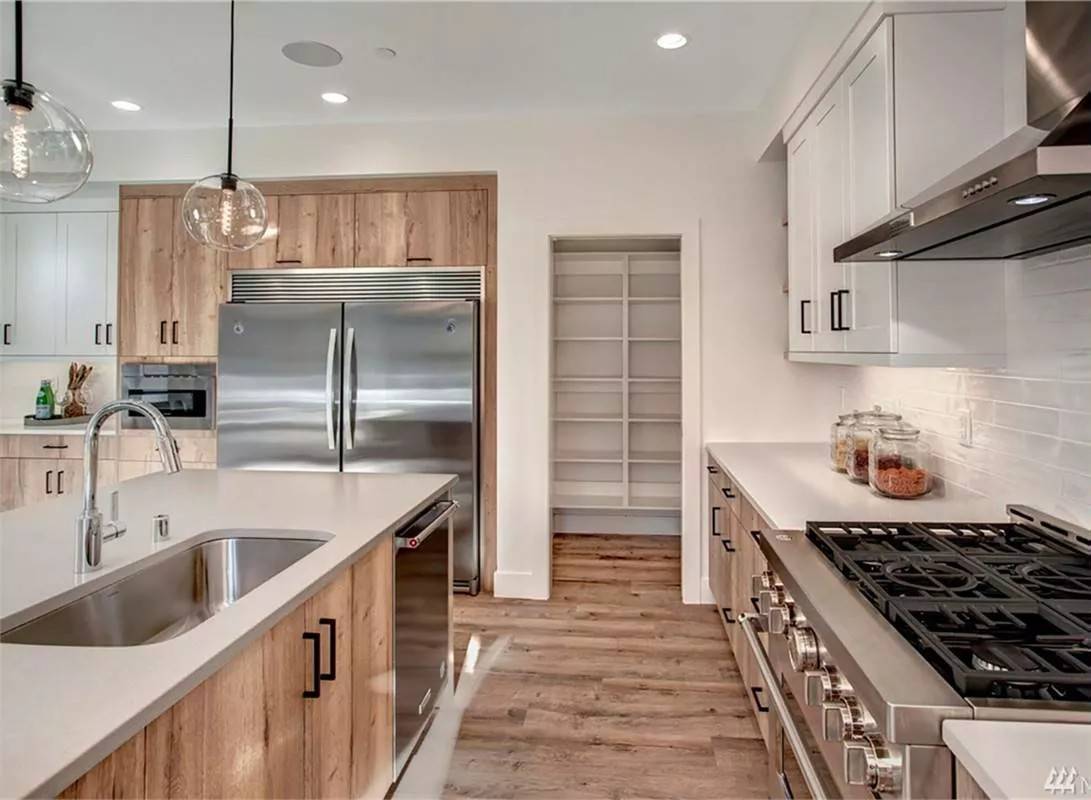 The kitchen includes a walk-in pantry and a large sink fitted on the prep island.