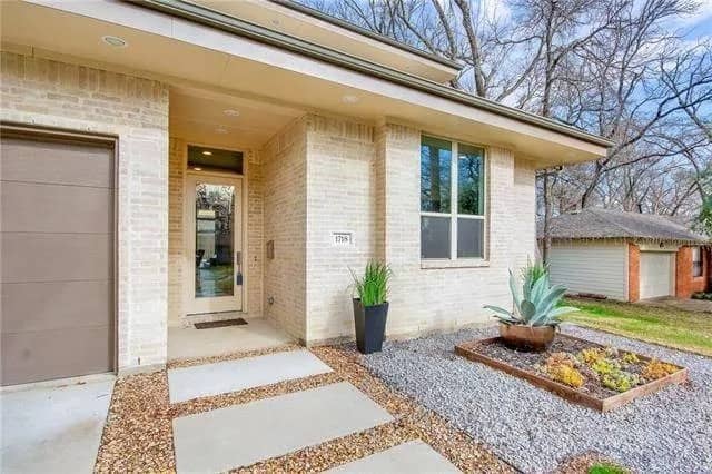 Covered entry with a glazed front door.