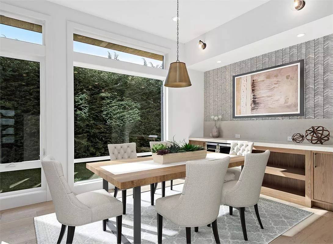Dining room with a buffet bar and a matching table surrounded by tufted chairs.