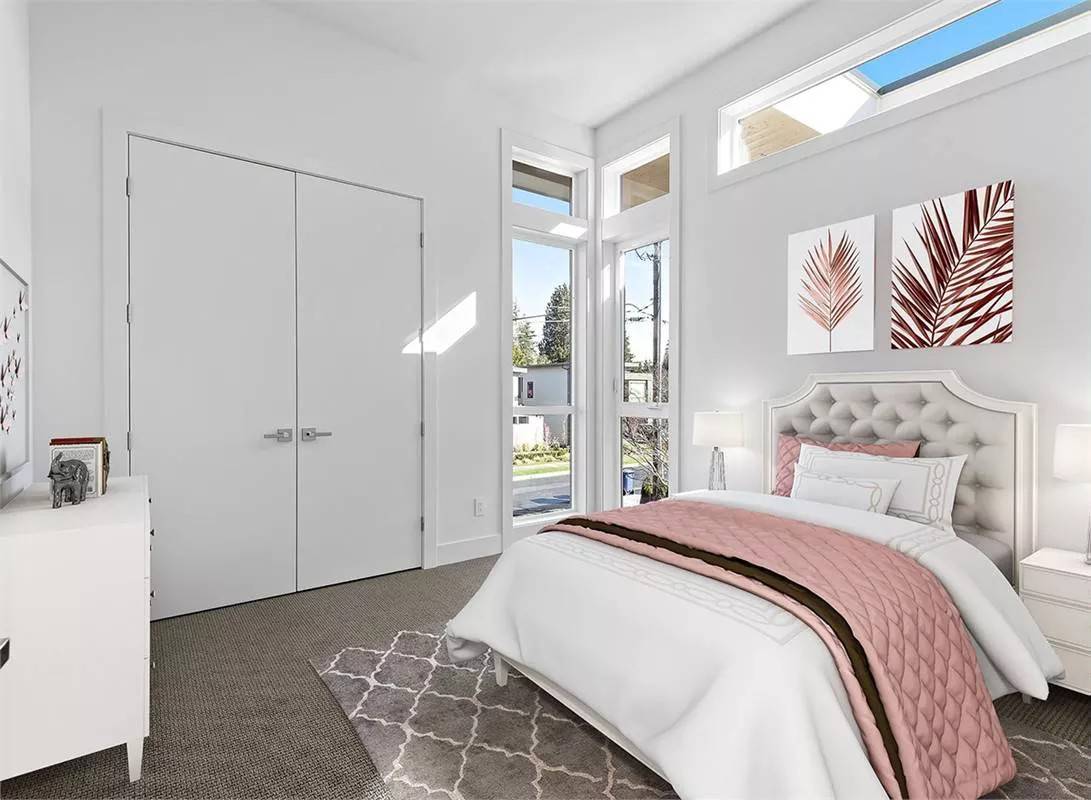 Secondary bedroom with a tufted bed, a built-in closet, and clerestory windows.