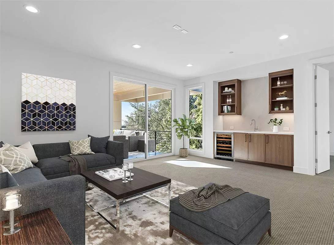 Bonus room with gray seats, a wet bar, and a private deck.