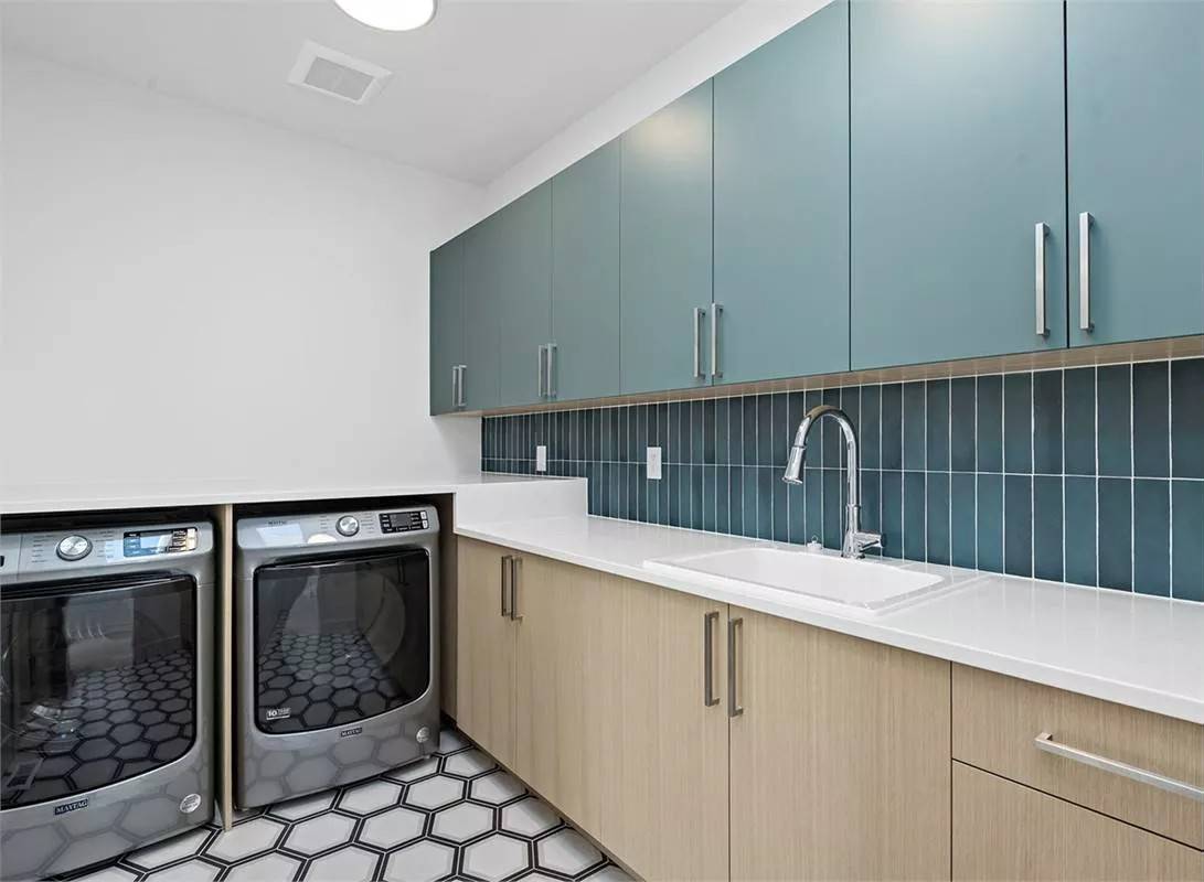 Laundry room with ample storage, a sink, and hex tiled flooring.