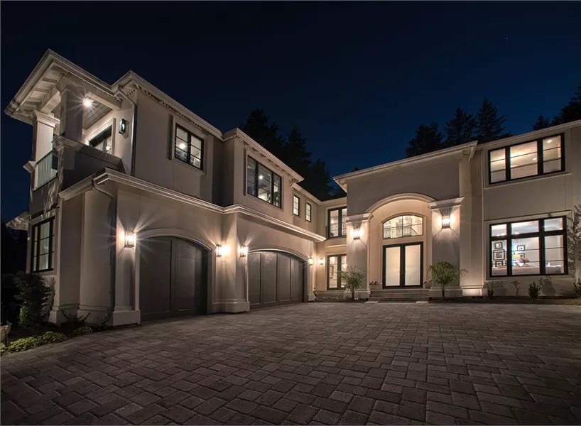 Front view of the house with a towering entry and a courtyard garage.