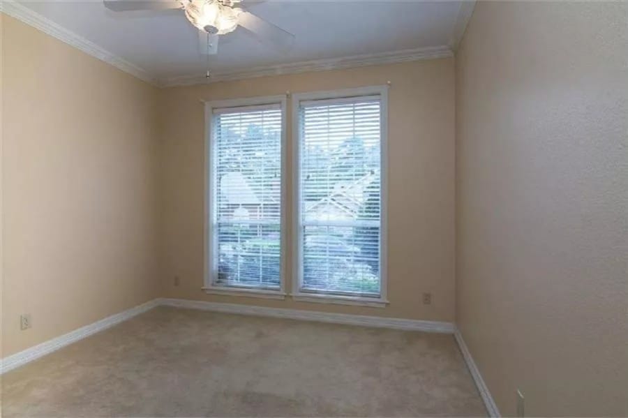 Bedroom with beige walls and a carpeted floor.