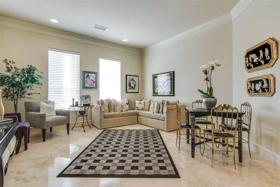 Living room with a V-shaped sofa, a velvet chair, and a 4-seater dining set.