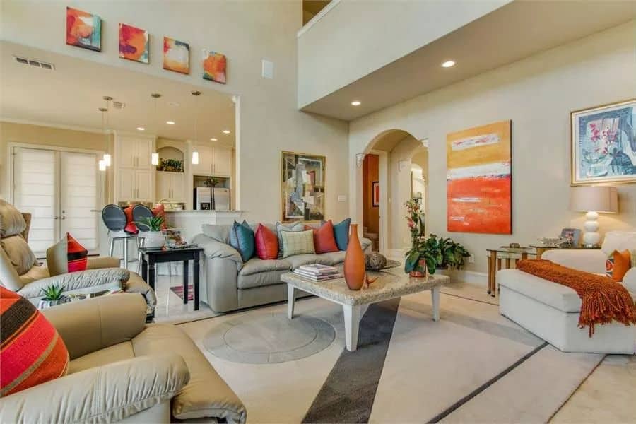 The family room includes a marble-top coffee table sitting on a large area rug.