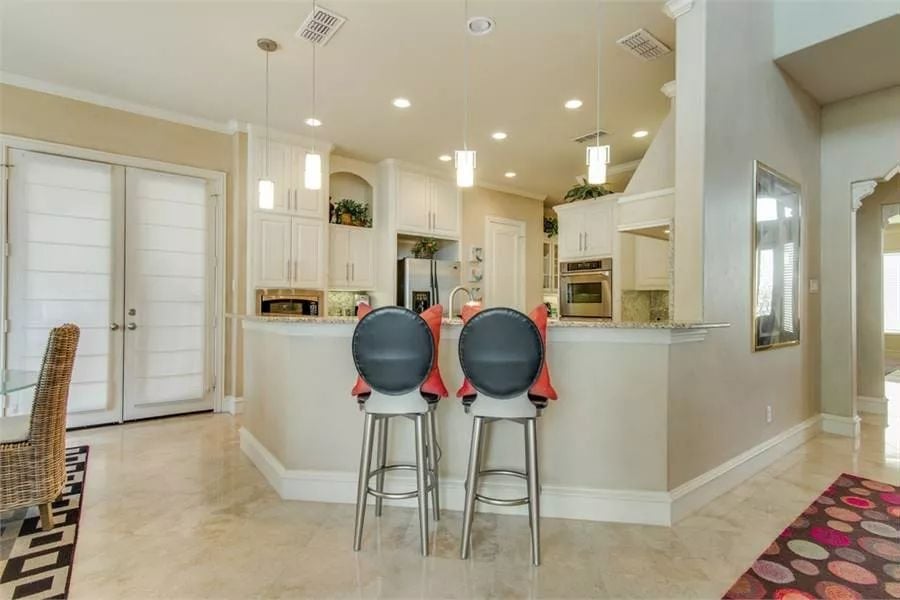 The kitchen includes a peninsula bar with seating for two.