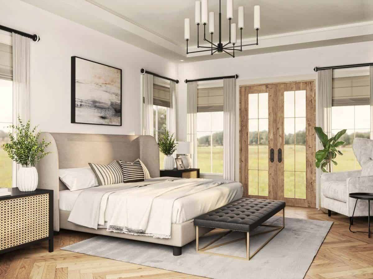 Primary bedroom with a wingback bed, a tufted bench, and a French door that opens to the rear patio.