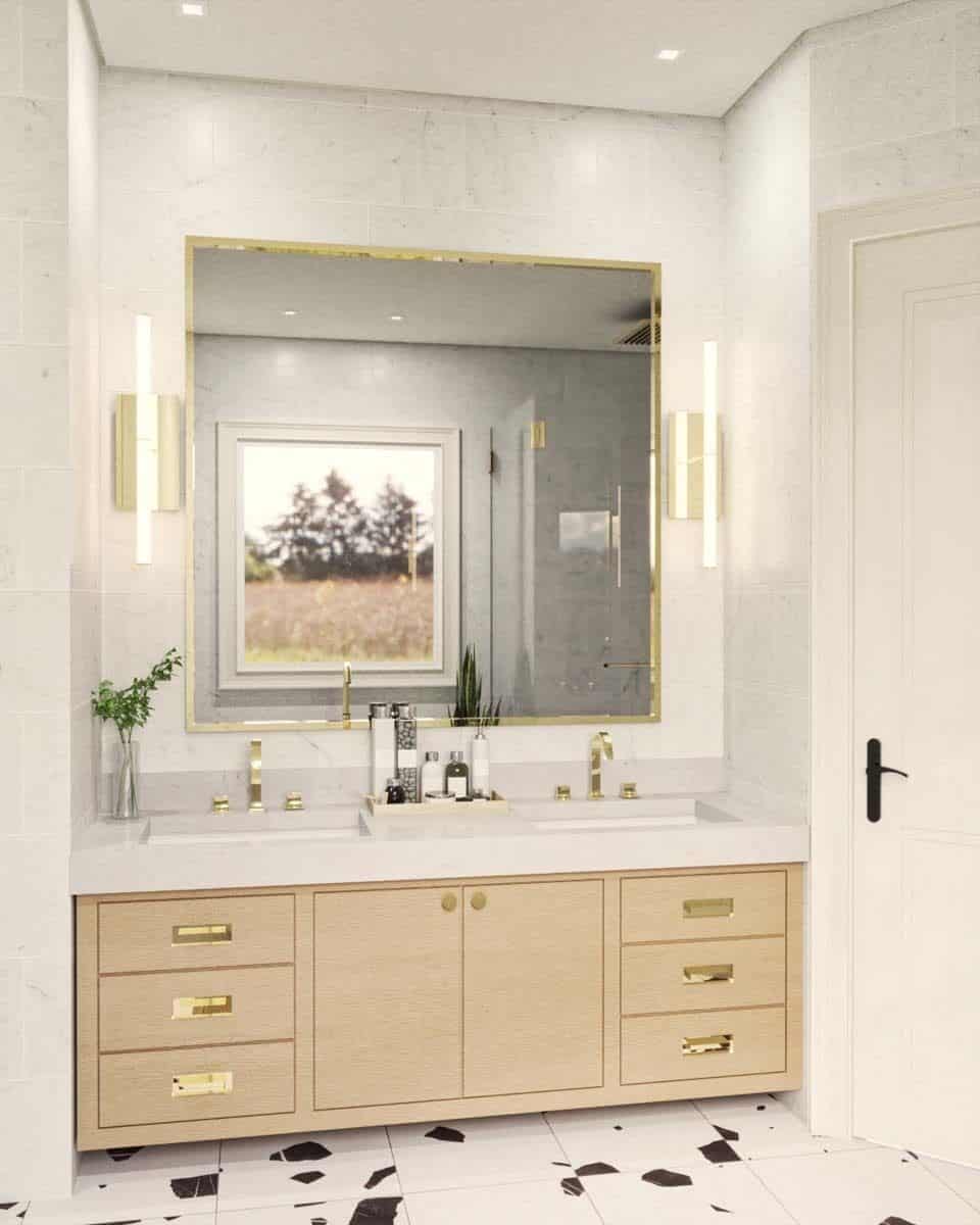 Primary vanity with two sinks, a marble countertop, and a brass-framed mirror.