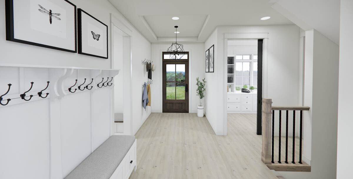 Foyer with a glazed front door and a storage bench with coat hooks.