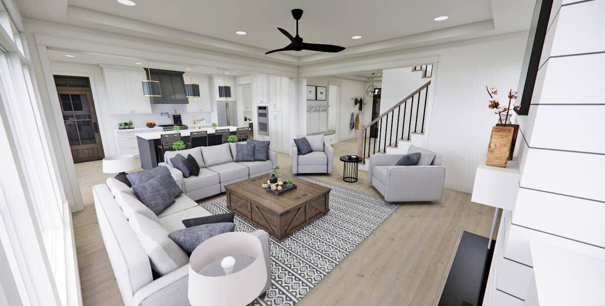 The great room includes a rustic coffee table over a patterned area rug.
