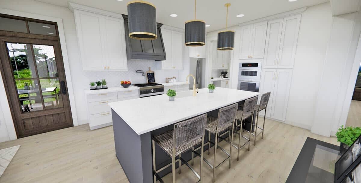 Kitchen with white cabinets, stainless steel appliances, and a center island with seating for four.