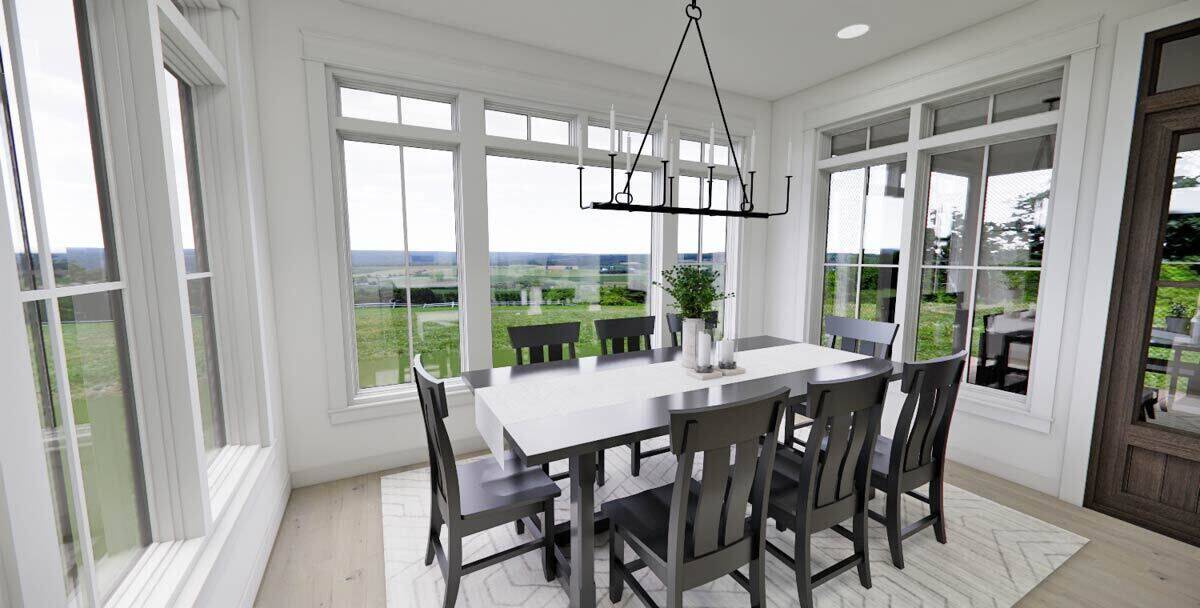 Dining room with an 8-seater dining set and surrounding windows overlooking the lush backyard.