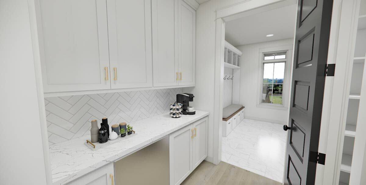 Butler's pantry with white cabinets, a marble countertop, and connecting mudroom and walk-in pantry.
