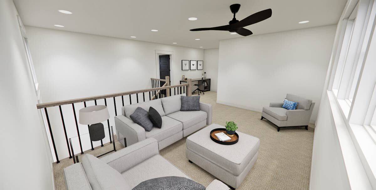 Loft with a ceiling fan and gray seats over the carpeted floor.
