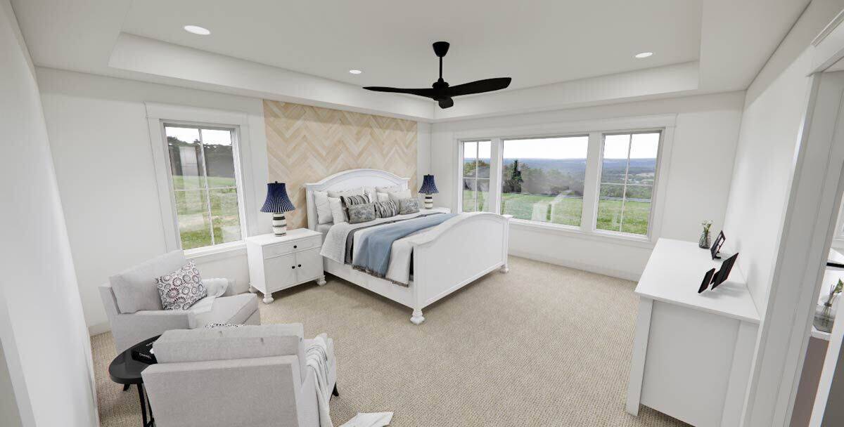 Primary bedroom with a carpeted floor and white furnishings under a tray ceiling.